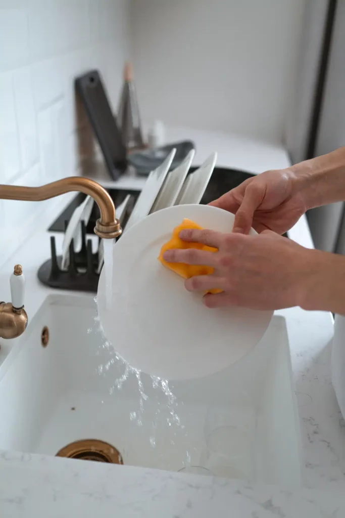 Washing dishes.